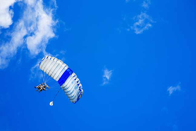 Skydiver flying with Parachute opened