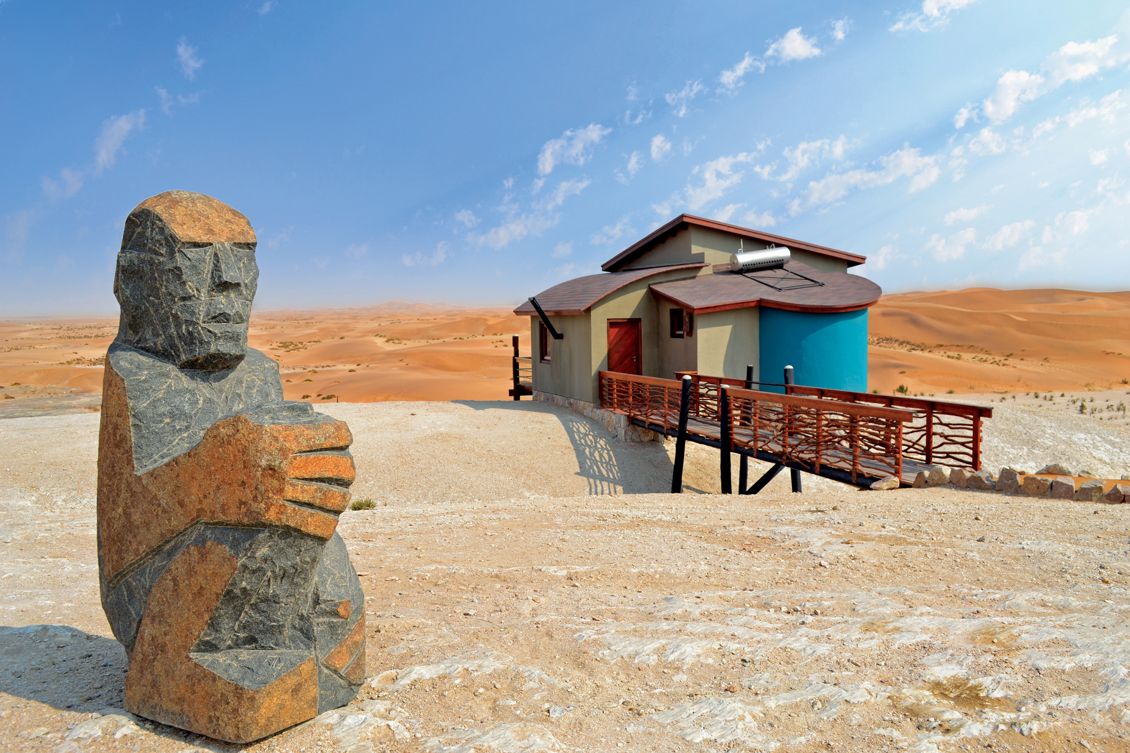 Stone sculpture and colourful Desert Breeze bungalow overlooking the Namib dunes