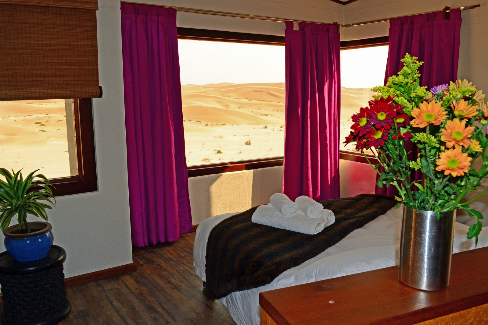 Desert Breeze bedroom with colourful flowers, purple curtains and views of the Namib dunes