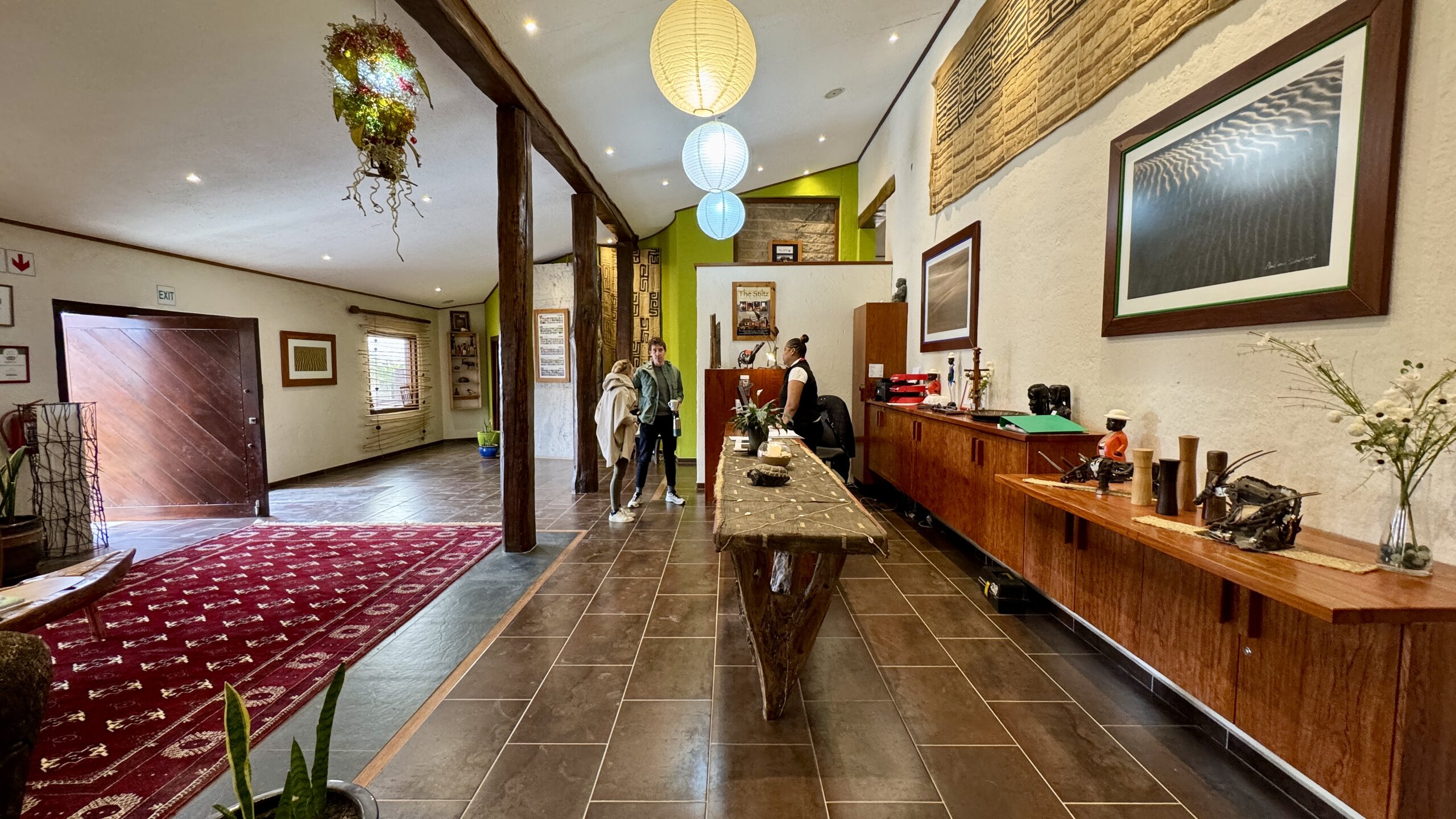 Desert Breeze reception interior with timber counters and desert artwork