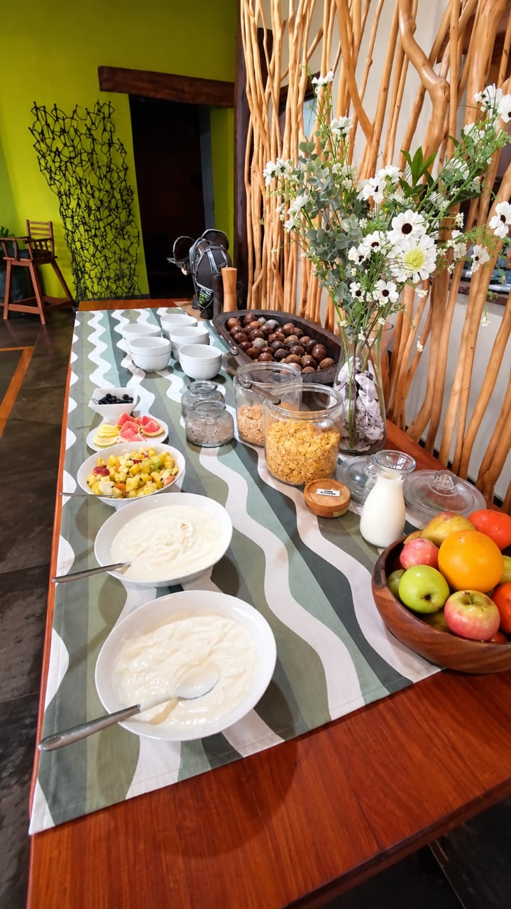 Yoghurt, fruit and cereal arranged on the breakfast buffet