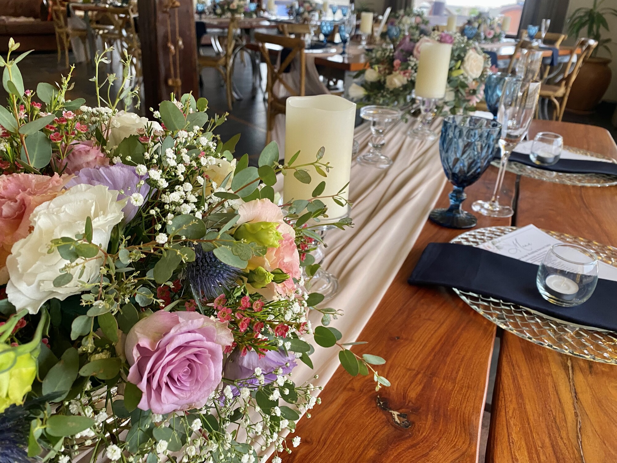 Floral centrepiece and candlelit event table setting