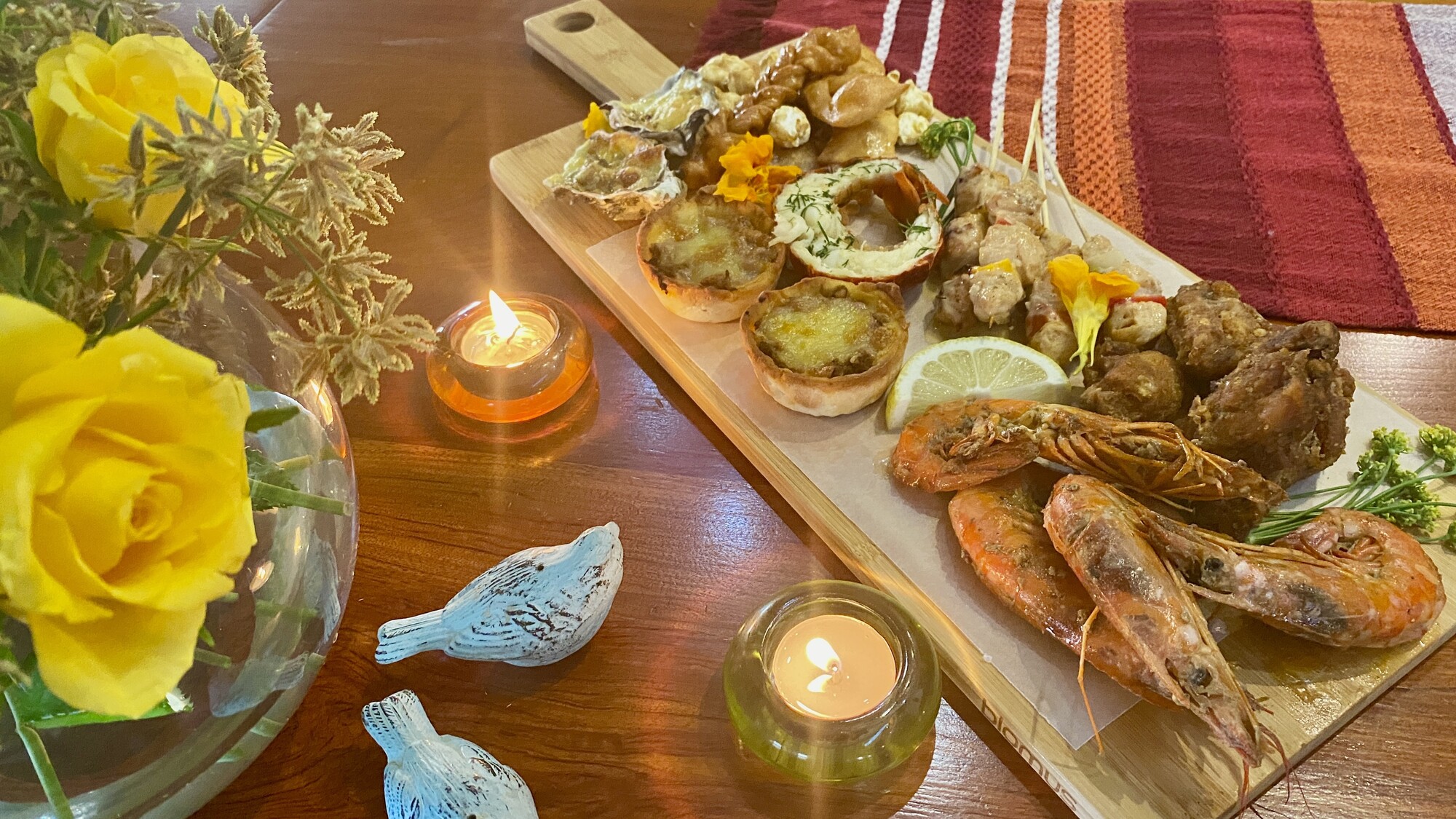 Savoury canapes served with flowers and candles
