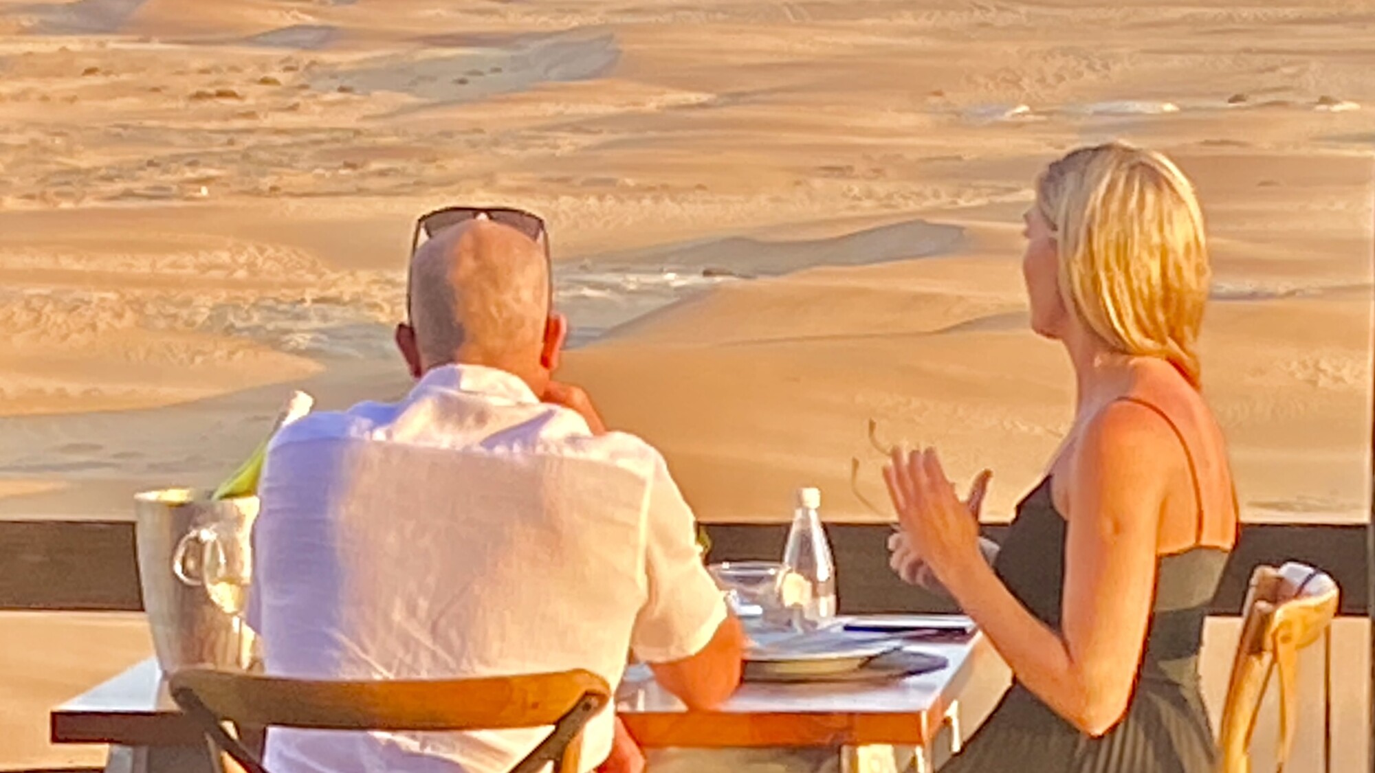 Guests enjoying drinks on the terrace overlooking the Namib dunes