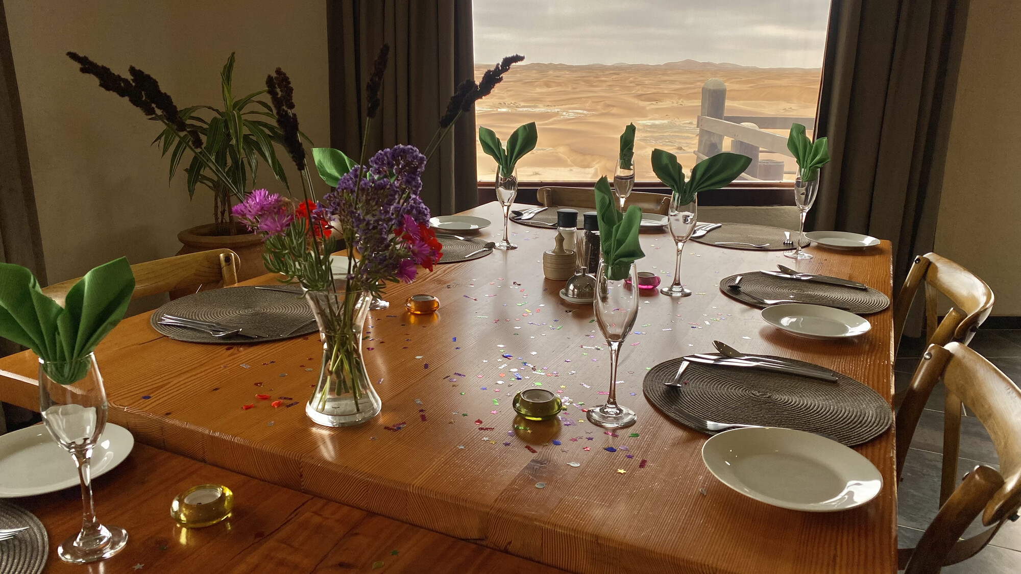Dining table set with flowers and green napkins