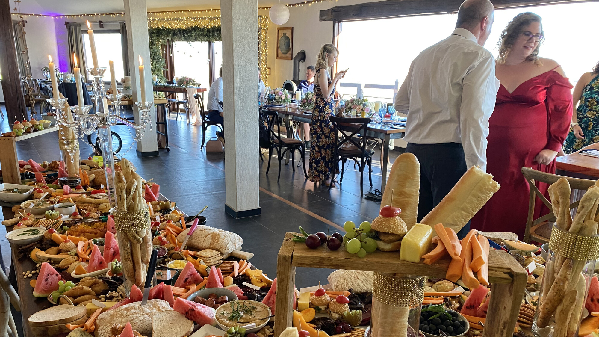 Guests beside a colourful event buffet at Desert Breeze