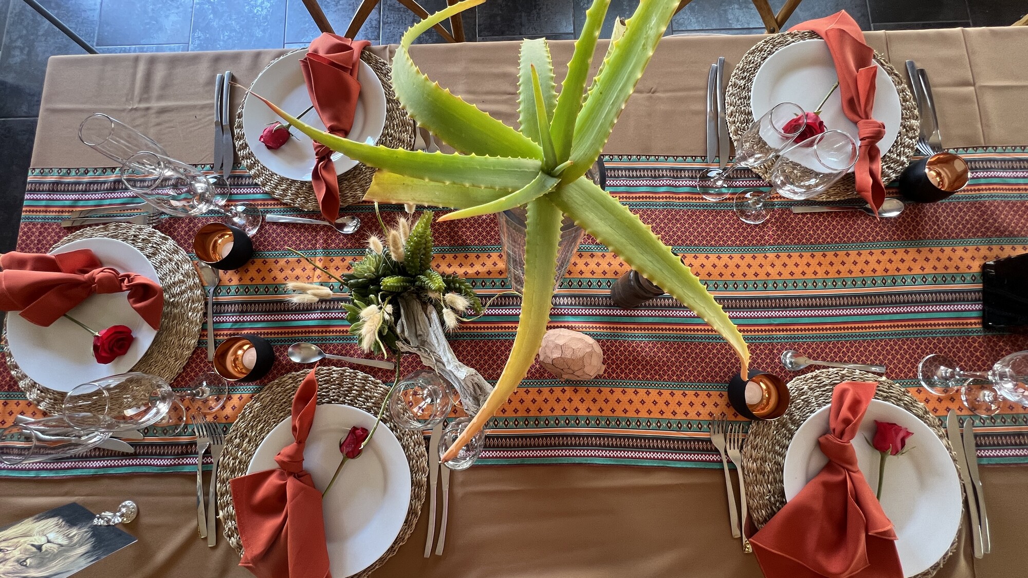 Table setting with patterned textiles and an aloe centrepiece