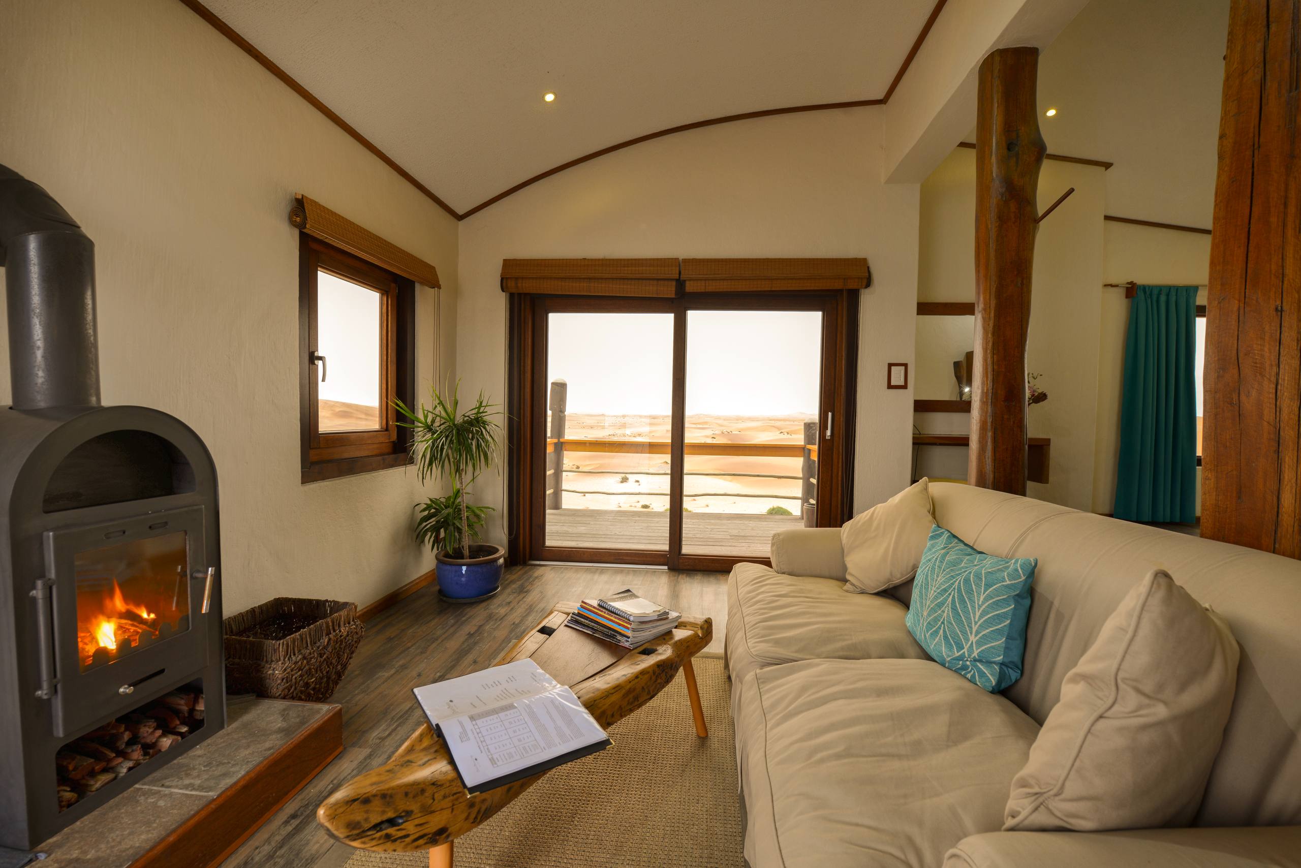 Dune Bungalow lounge with fireplace and panoramic Namib dune views